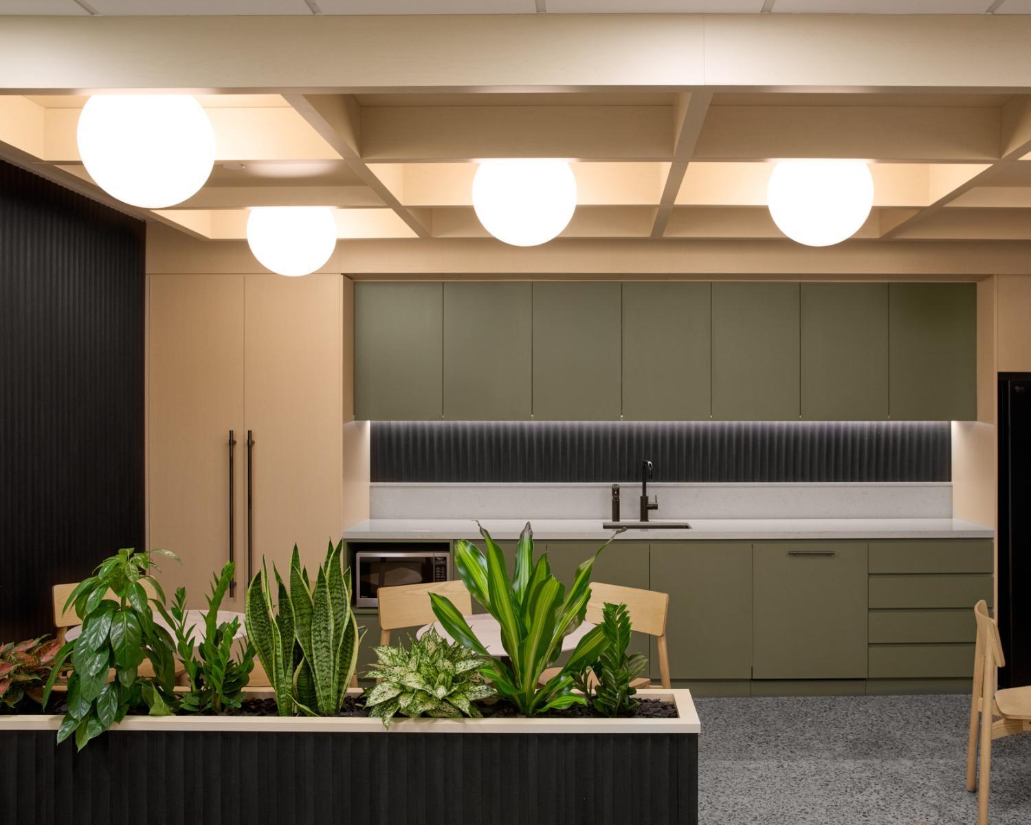 Warm and elevated office kitchen design by Amicus