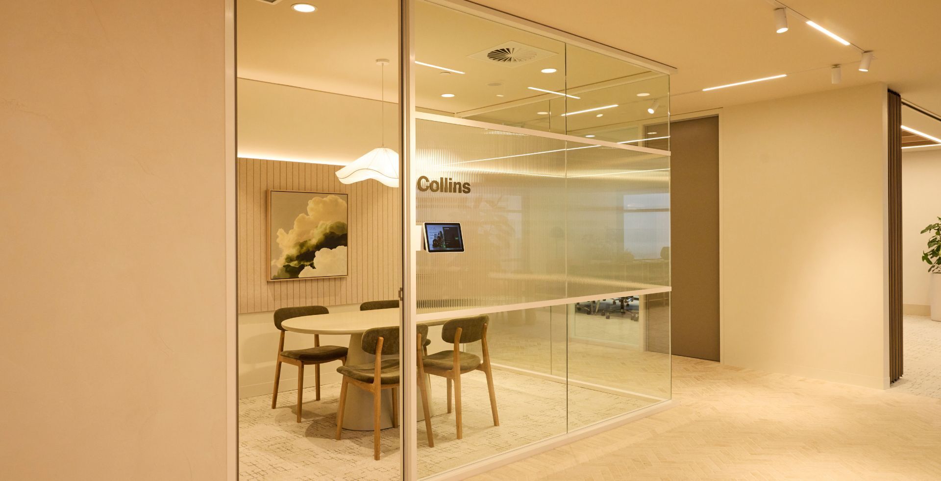Glazed meeting room with textured finishes, natural materials and seamless workplace connectivity.