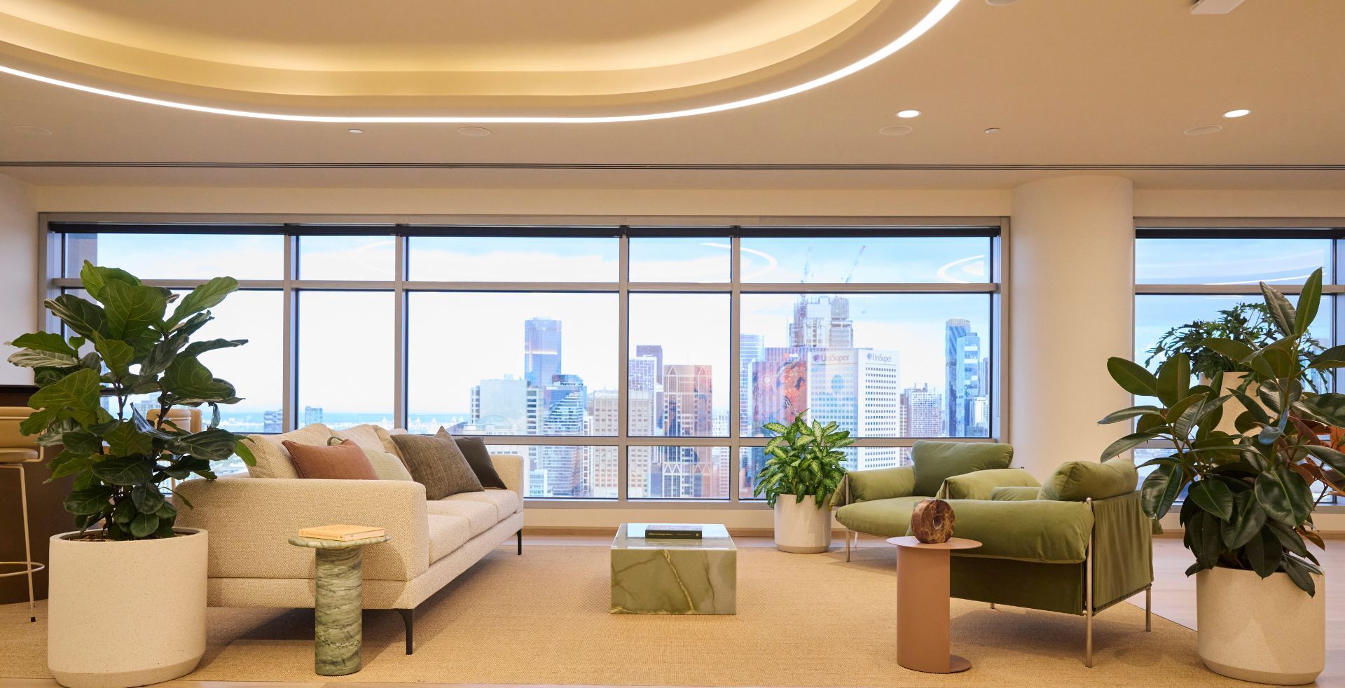 Reception and client arrival area framed by planting, curved lighting features and skyline views.