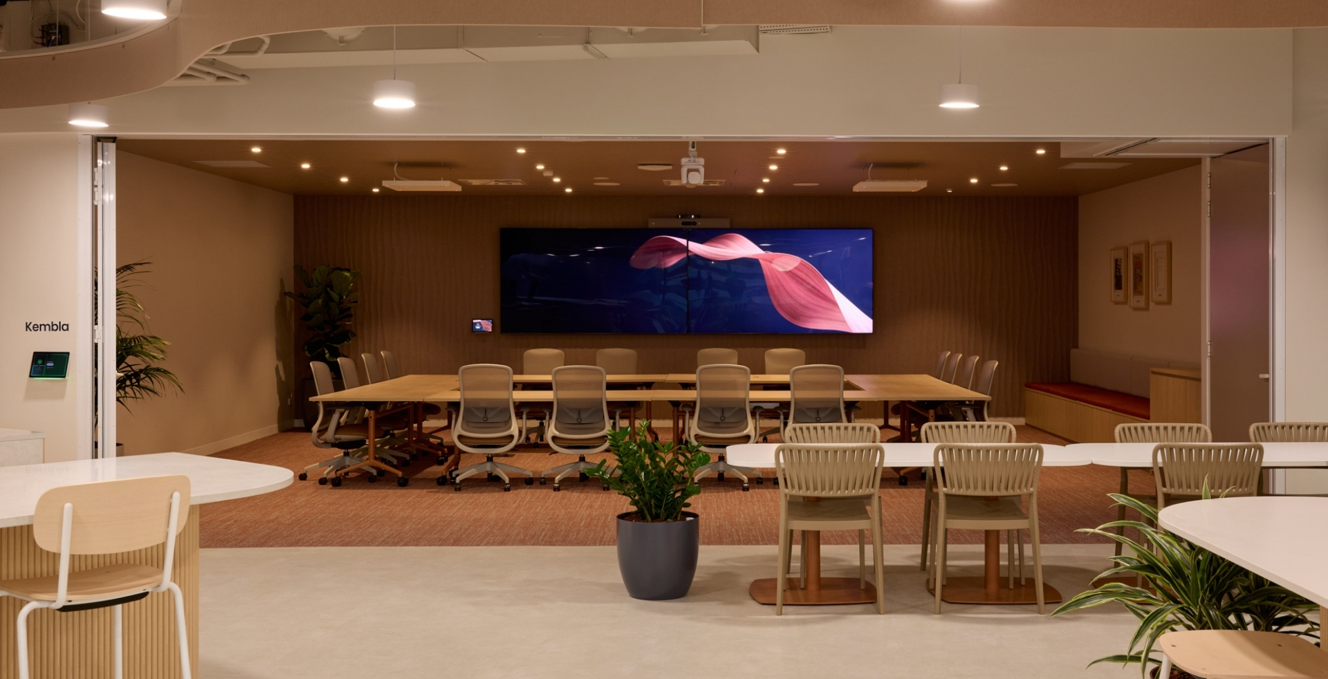 IRT boardroom transformed into a Town Hall space with integrated workplace technology by Amicus