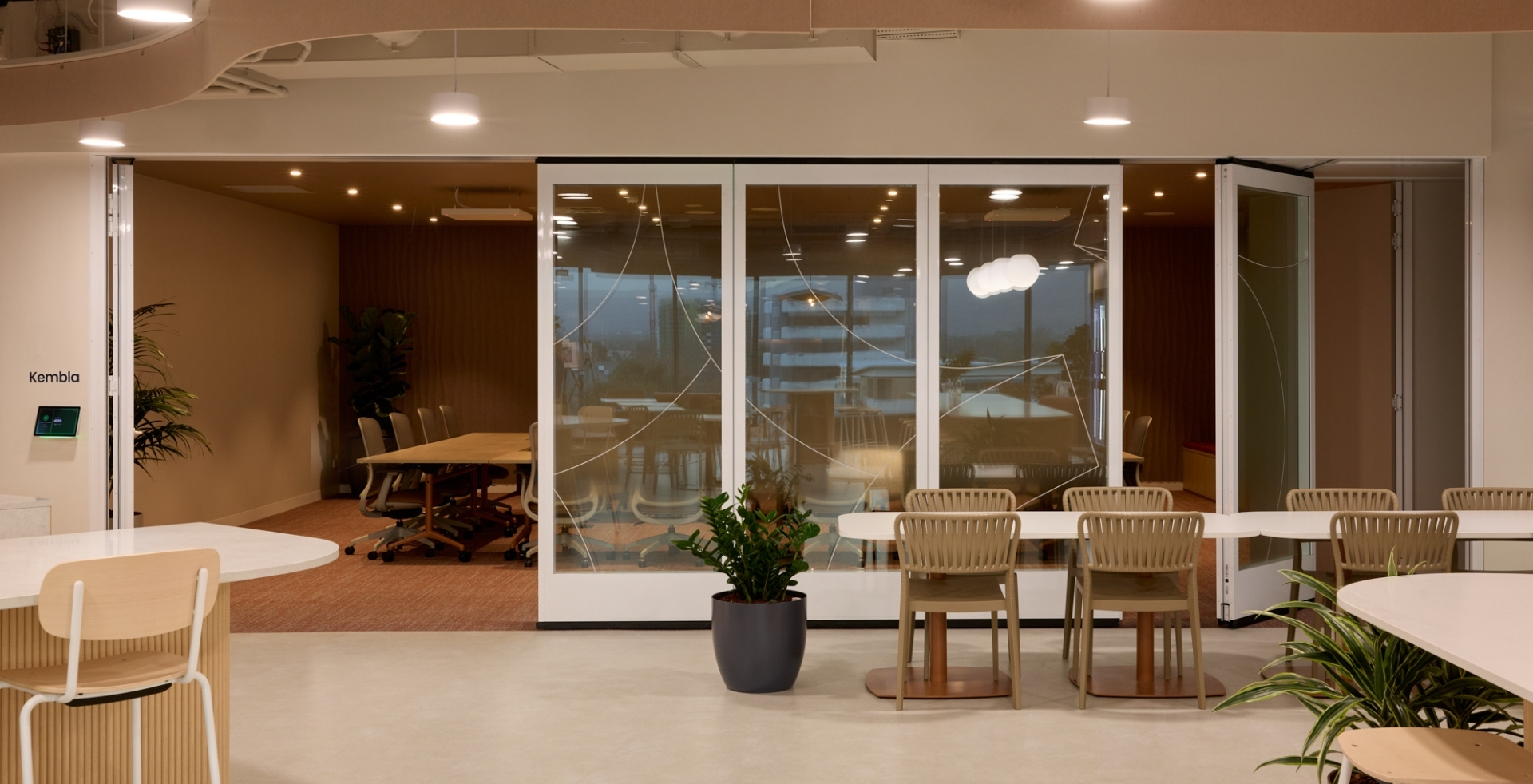 Flexible IRT boardroom opening into the workplace kitchen and social hub for larger gatherings