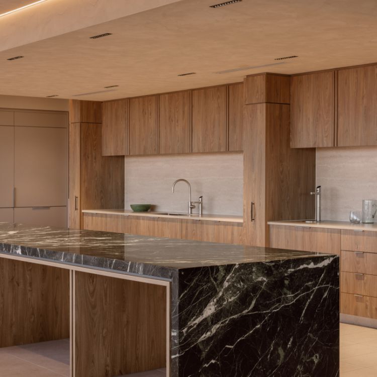 Green-black marble island and timber joinery in the Mazzei staff kitchen, an Amicus office fitout