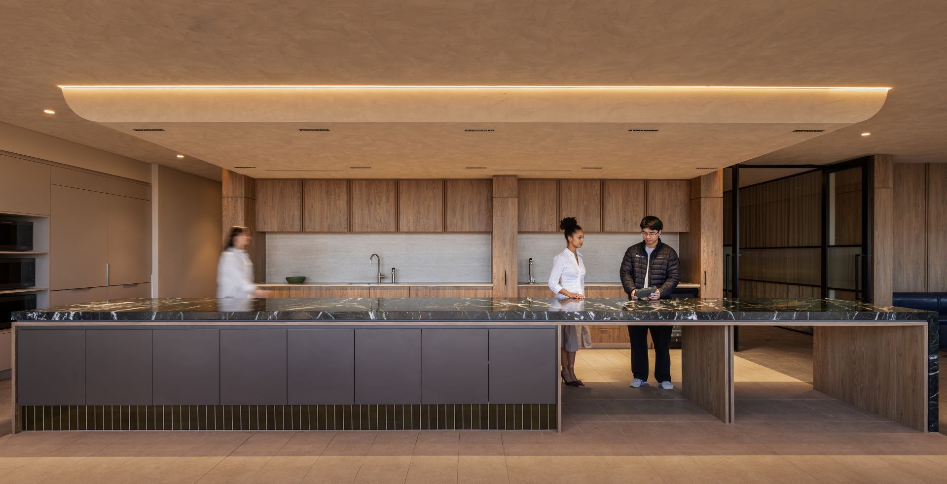 Marble-topped island bench anchoring the staff kitchen in Mazzei's Victorian office fitout by Amicus