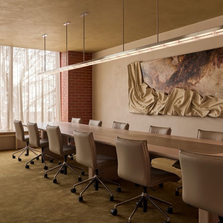 Long boardroom table, leather chairs and textured wall artwork in the Lowe Living office fitout delivered by Amicus