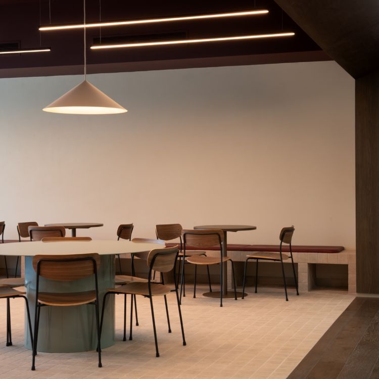 Breakout seating area with timber furniture and soft lighting.