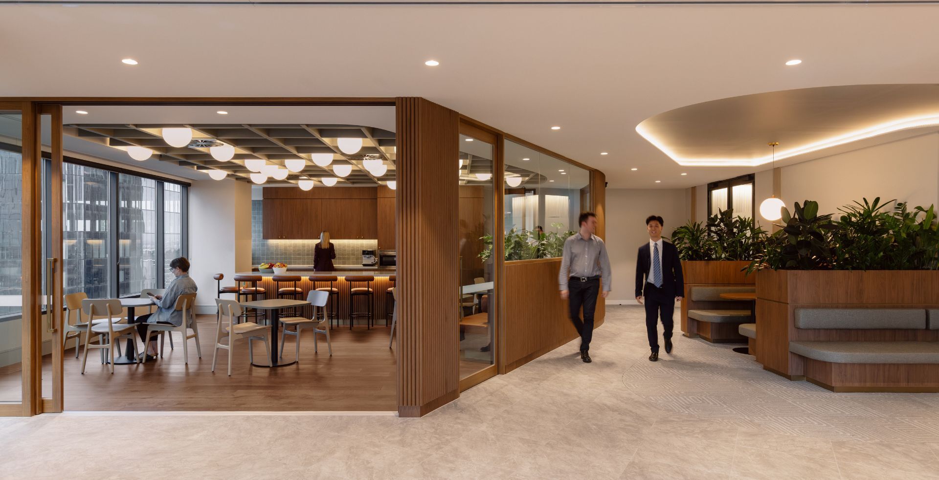 Warm breakout area with timber joinery, feature lighting and integrated seating.