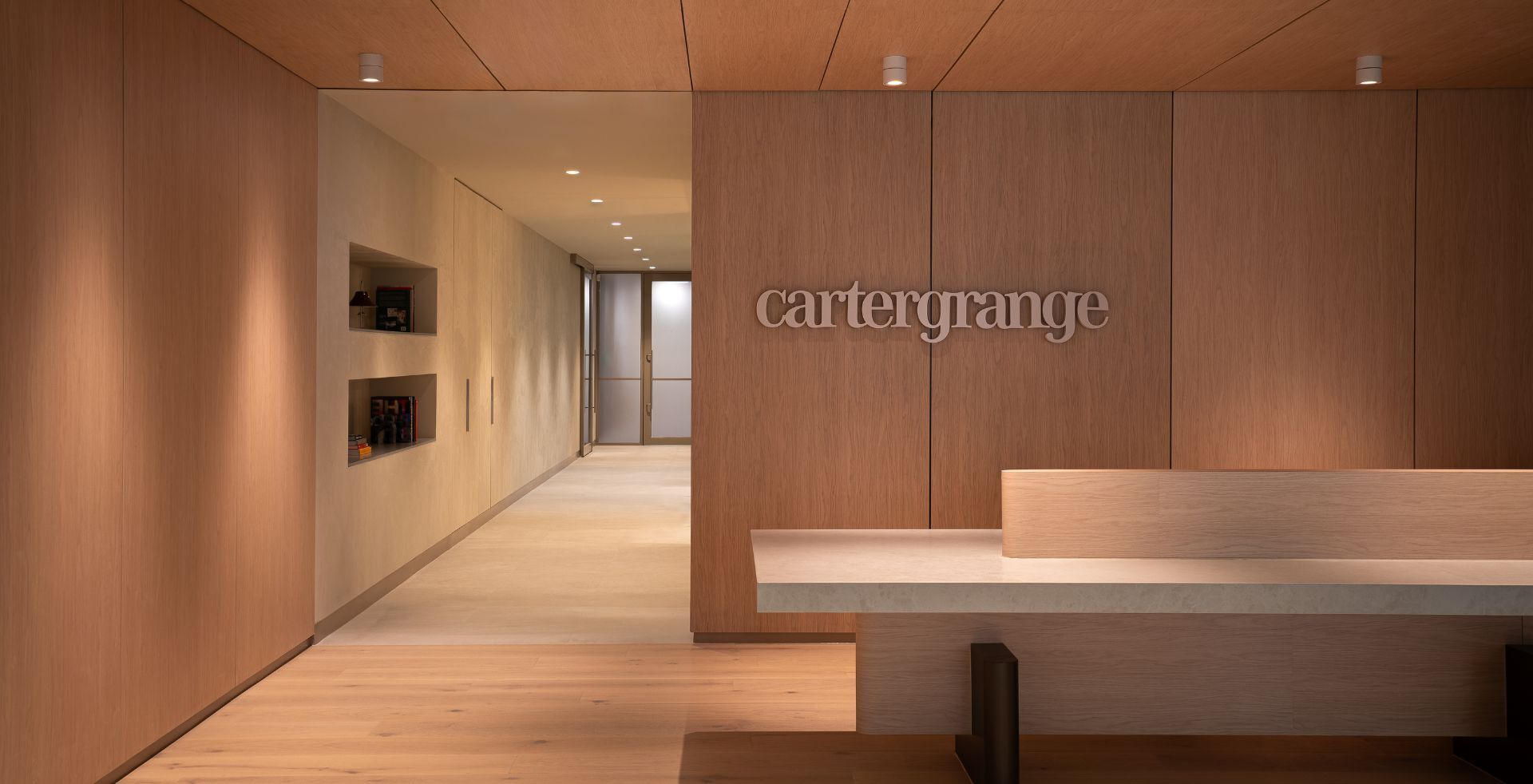 Carter Grange reception with timber wall panelling and stone desk