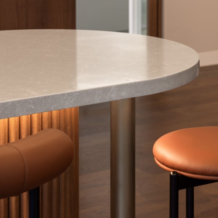 Material detail featuring stone benchtop, timber joinery and seating