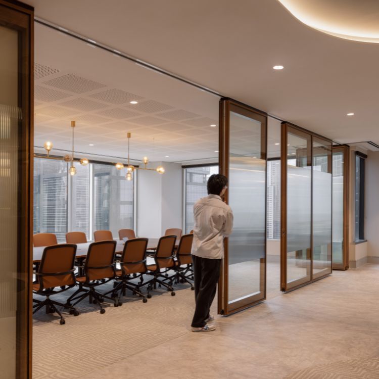 Flexible meeting room suite with operable glass walls in Gilchrist Connell’s Melbourne office fitout at 530 Collins Street.