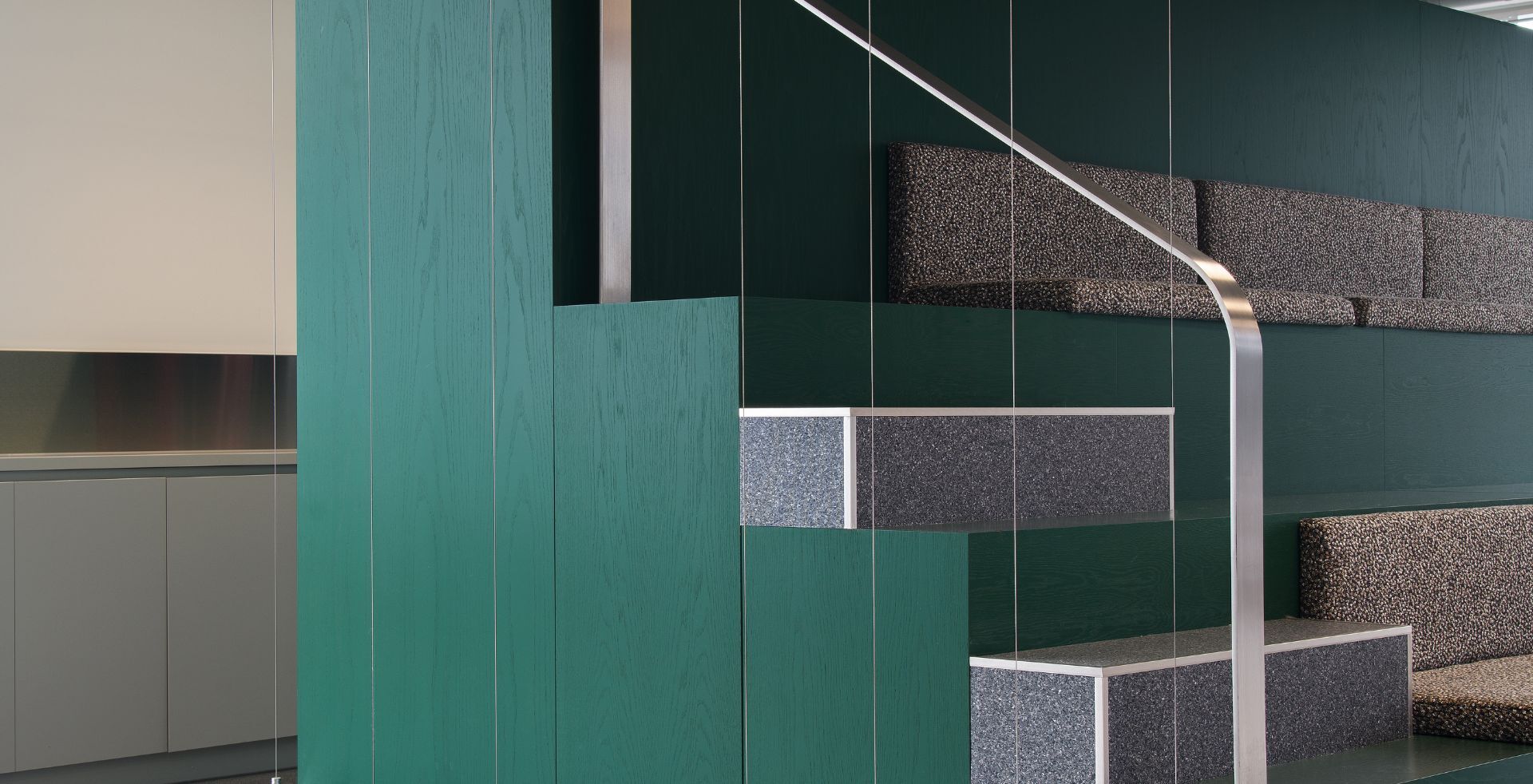 Tiered collaborative seating with green timber panelling and integrated steps