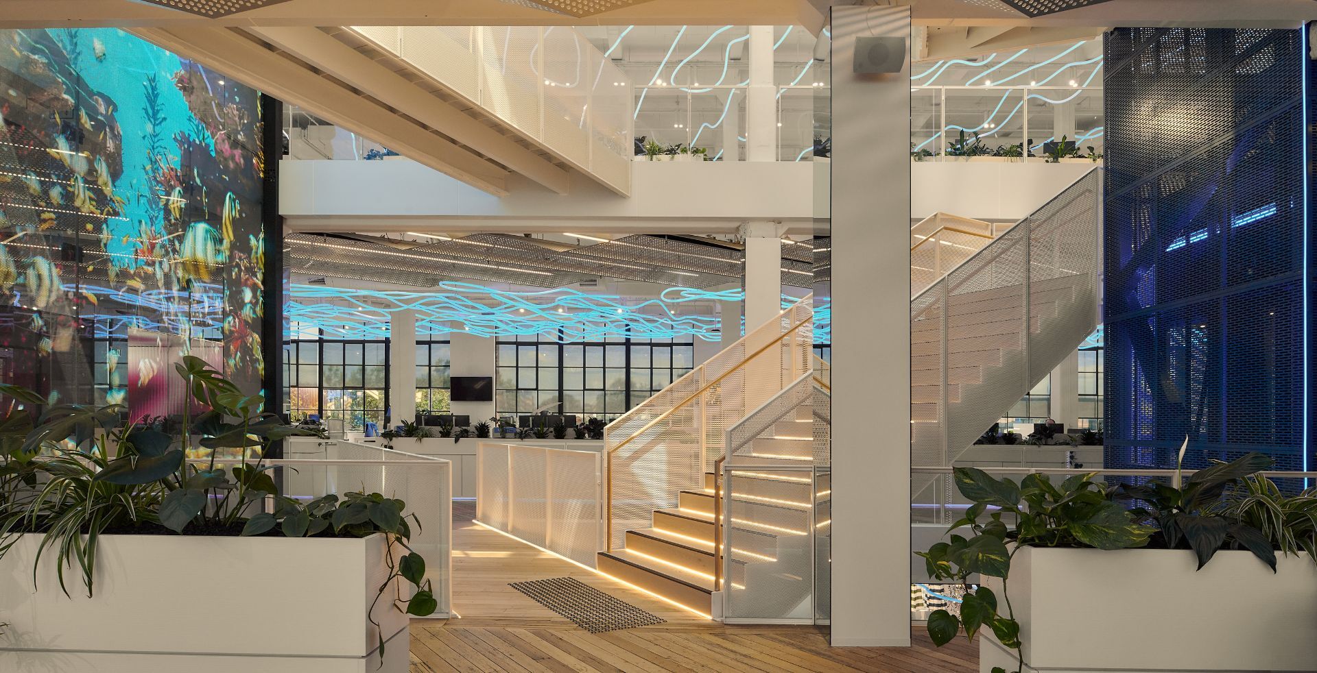 Workspace with LED glass wall and atrium staircase