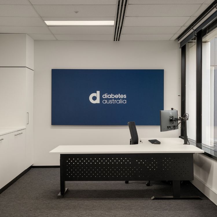 Private office space featuring a white top, black mesh panelled desk
