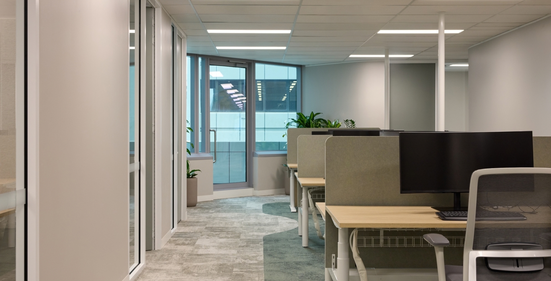 Open-plan office workspace featuring rows of modern desks in Gilchrist Connell's office.