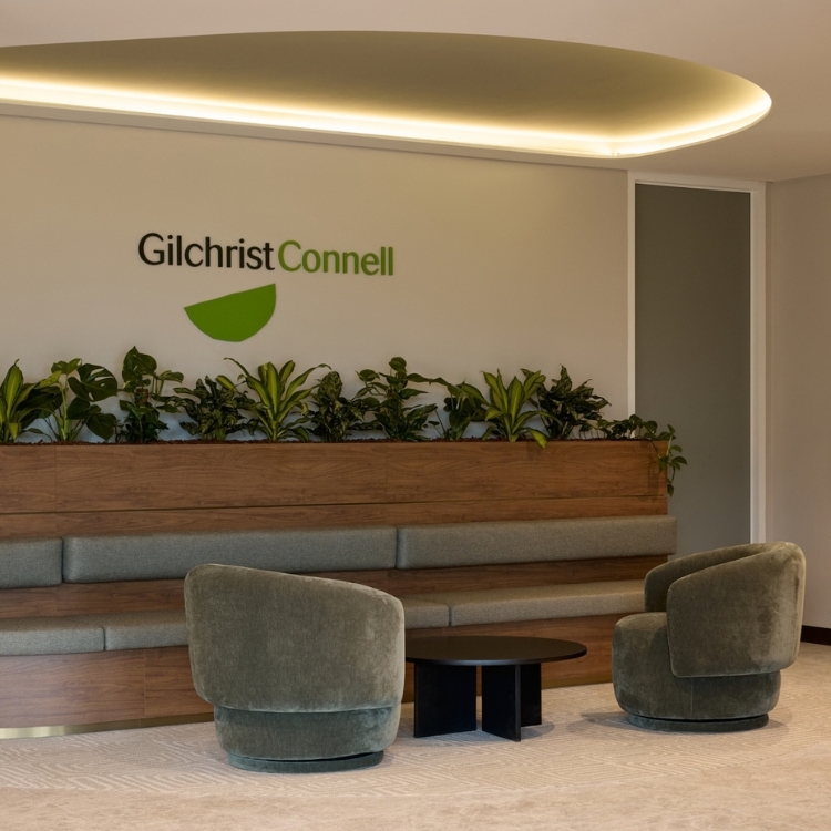 Modern reception area with built-in seating and curved lighting panel in Gilchrist Connell’s office.
