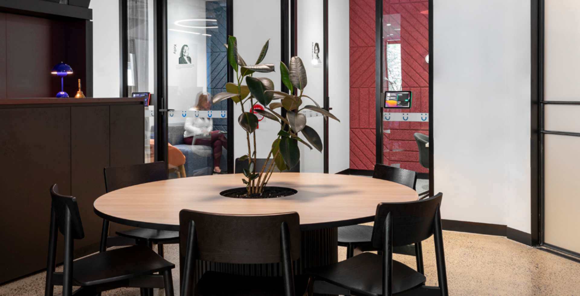 Round timber meeting table in office