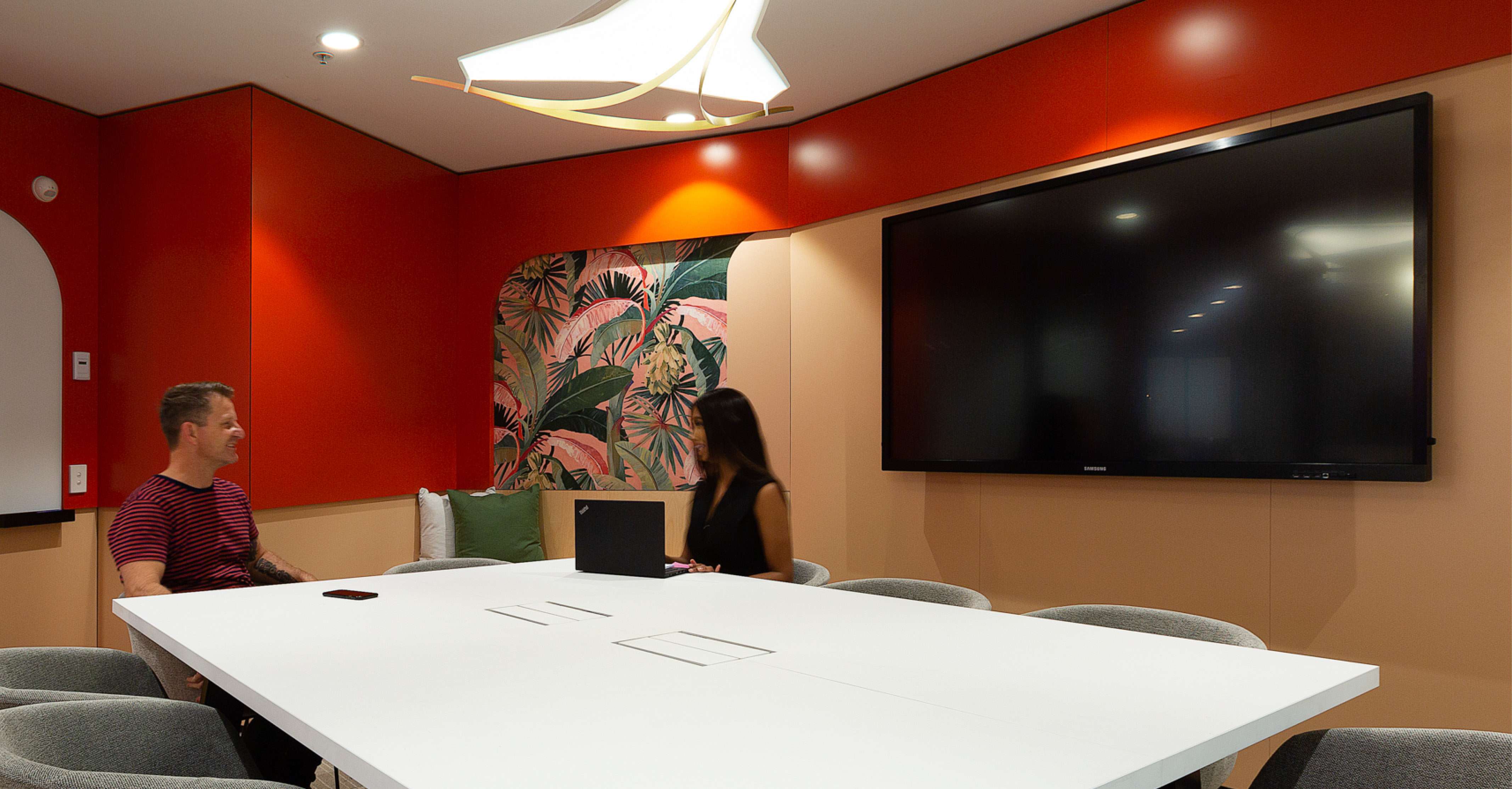 People collaborating in a technology enabled meeting room