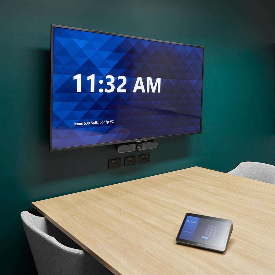 A modern conference room used by the Hydro project team features a flat-screen TV displaying 