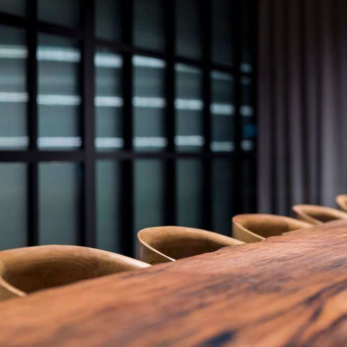 Close-up photograph of finely crafted wooden chairs and table.