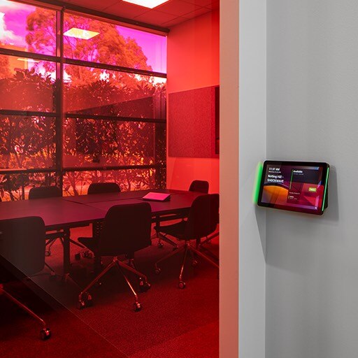 A conference room with a tablet display at the entrance. 