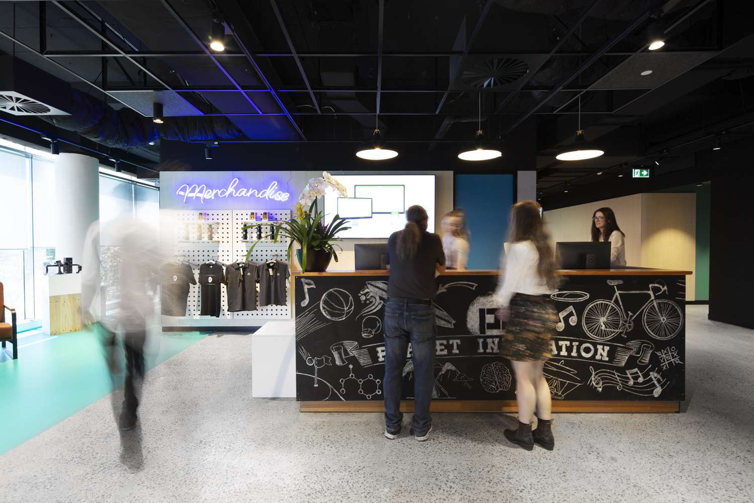 Merchandise store presented behind blackboard reception desk with lots of chalk drawings on it.