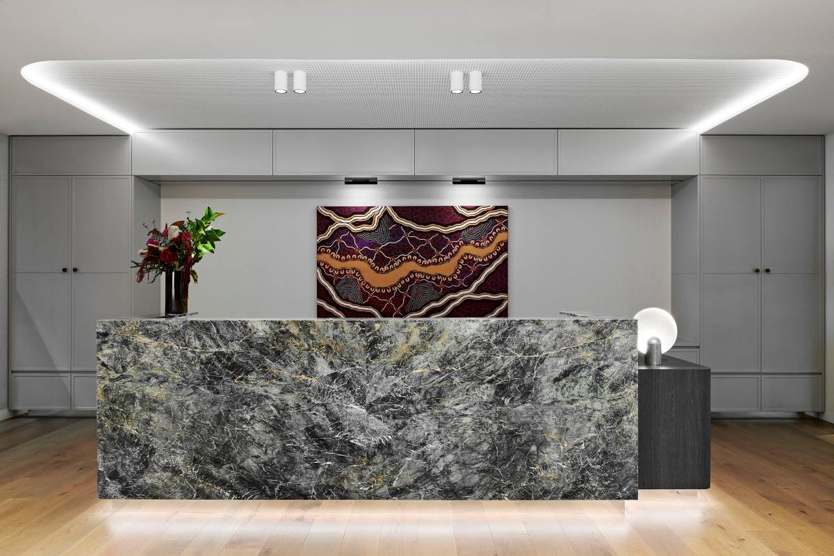 Marble reception desk with flowers, Australian indigenous art and lots of light. 