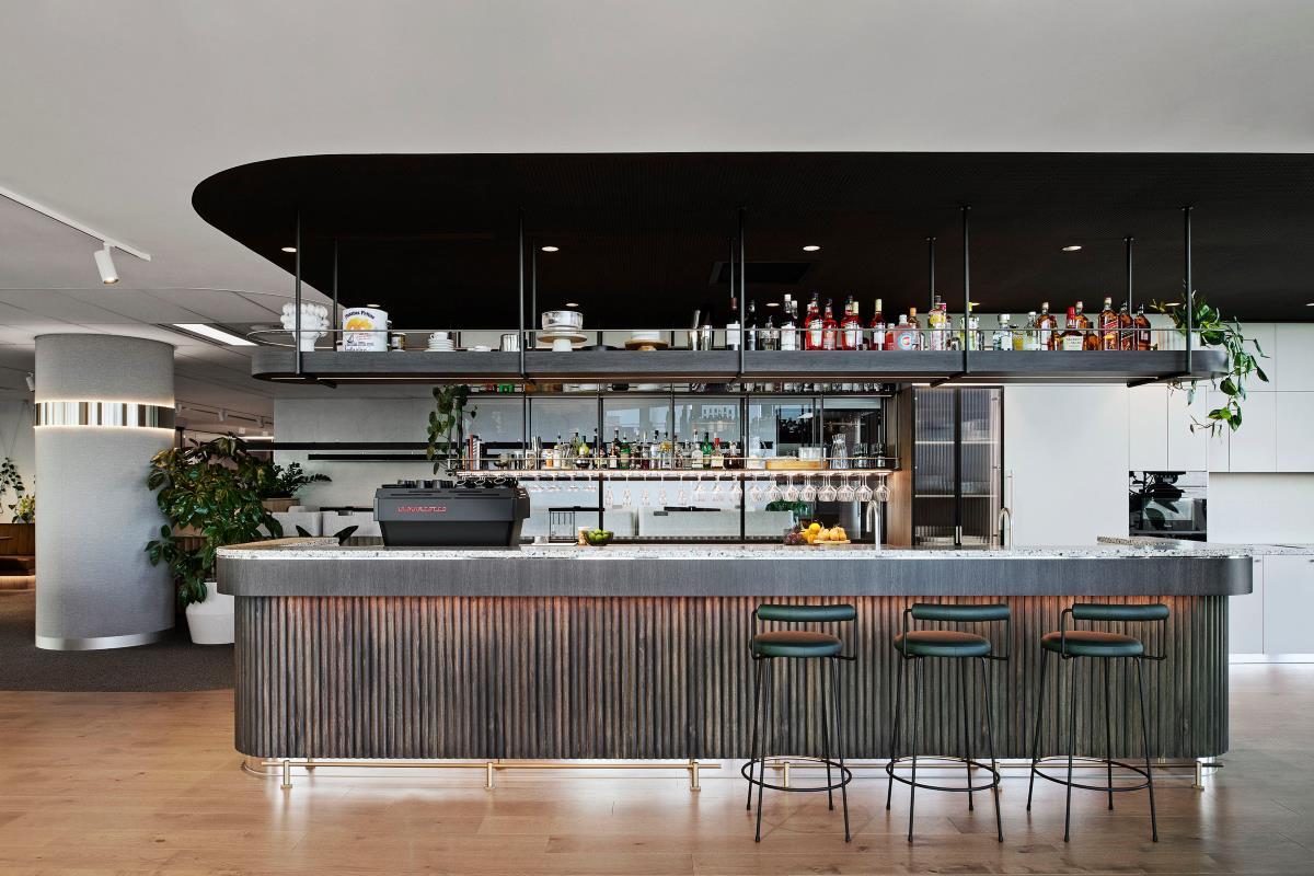 Office bar with modern and rustic touches as well as inviting plants and lots of light. 