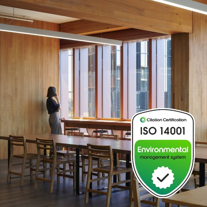 iso 14001 certified logo against a workplace background